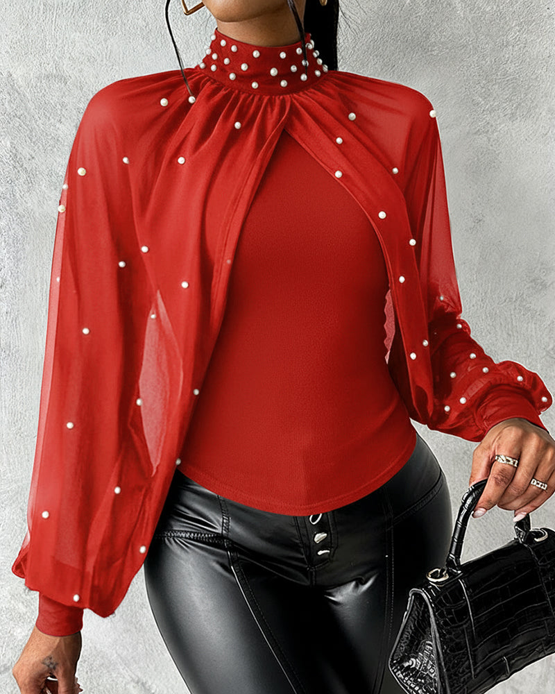 Top ajustado de chiffon con cuello alto, drapeado y manga capa; paneles entrelazados, fruncido y espalda con recorte; con perlas decorativas